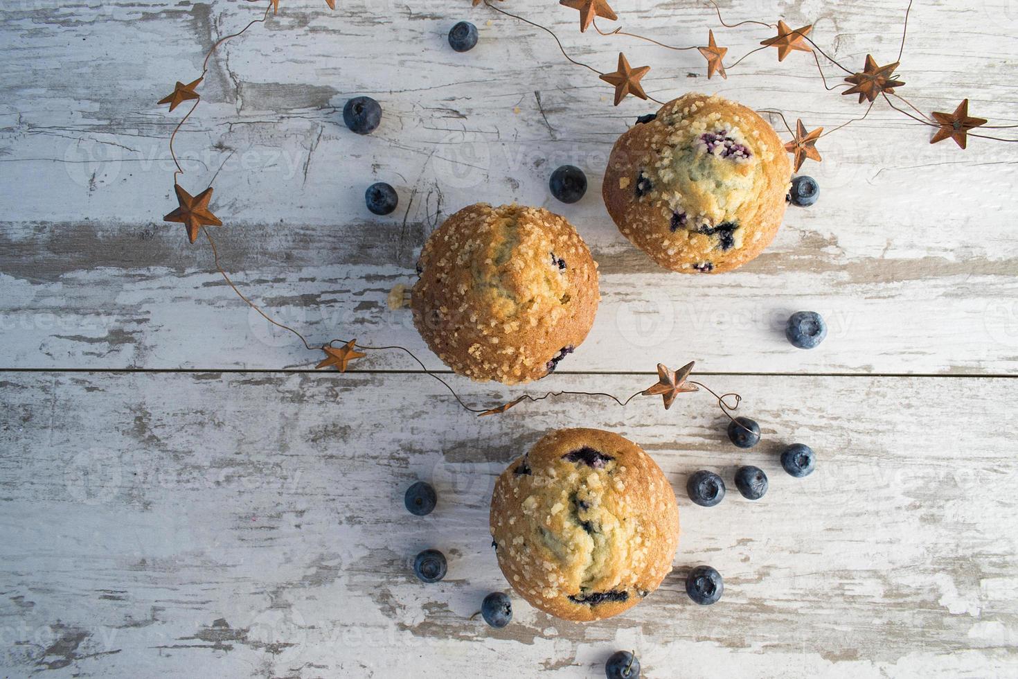 homemade blueberry muffins on rustic wood top view photo