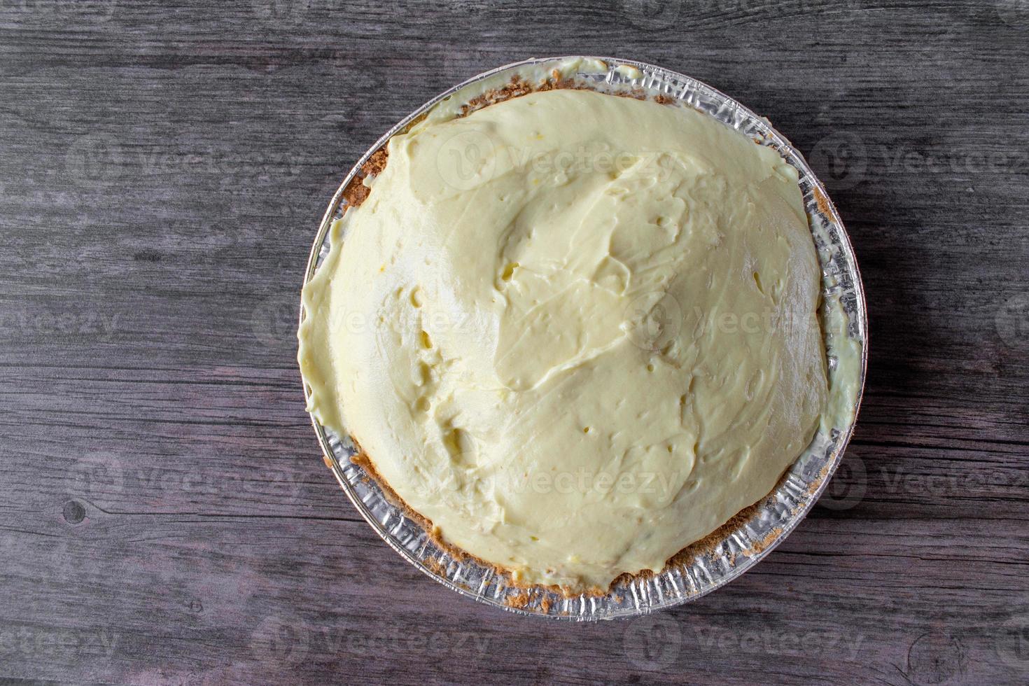 vanilla pudding pie with graham cracker crust in tin pie pan 8724687
