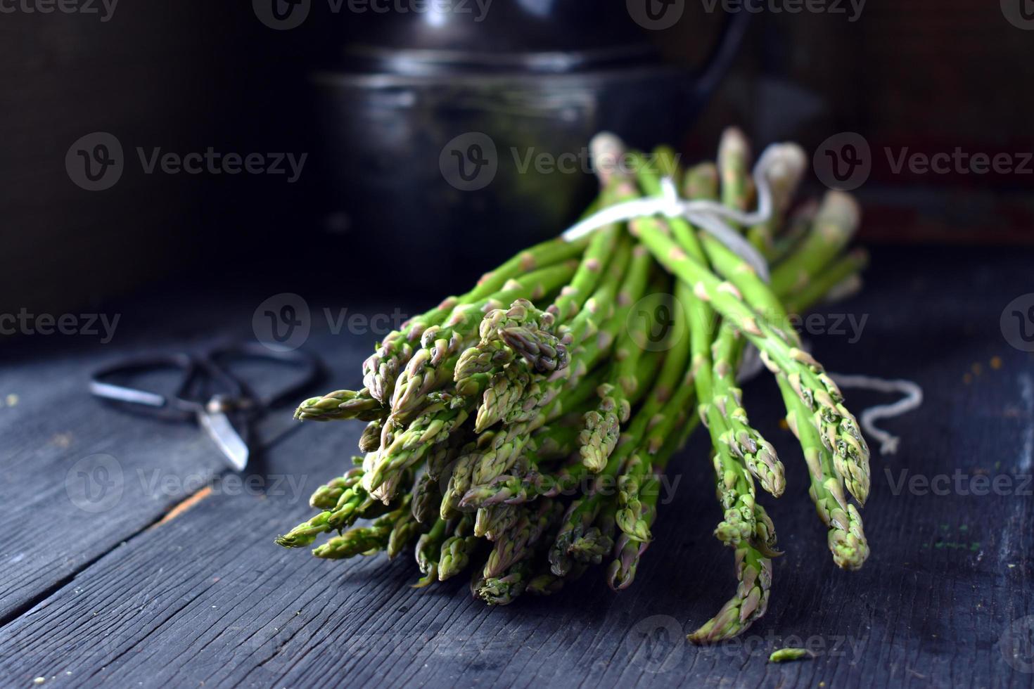 Fresh Asparagus bundle in rustic farmhouse setting photo