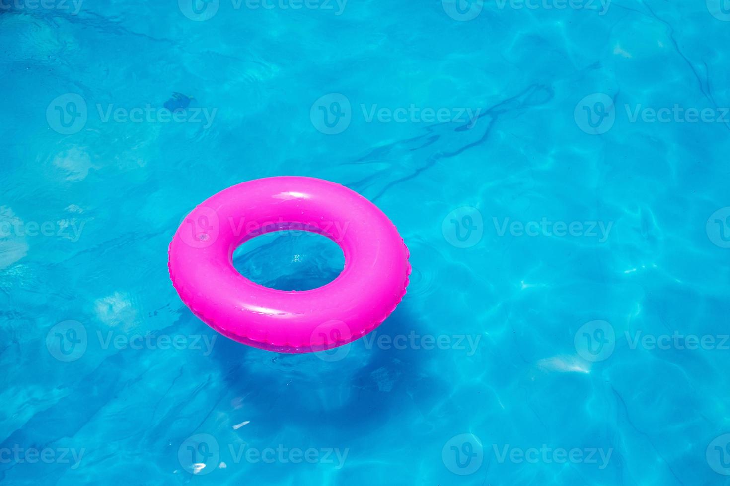 toy swim float in bright blue pool water photo