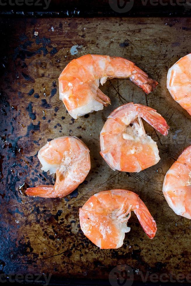 fresh shrimp with butter on baking pan flat lay photo