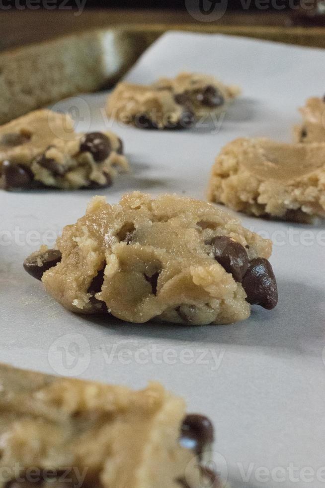 raw chocolate chip cookie dough on baking sheet photo