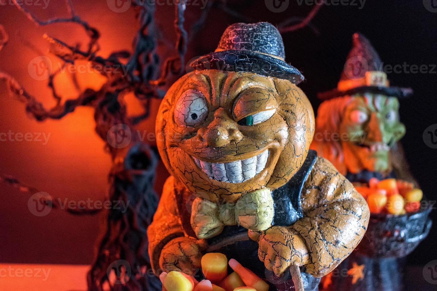 Halloween characters in spooky background collecting candy corn photo