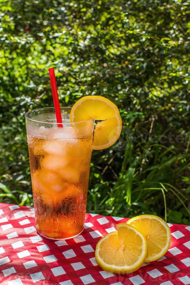 ice tea with lemon on summer picnic table outdoors photo