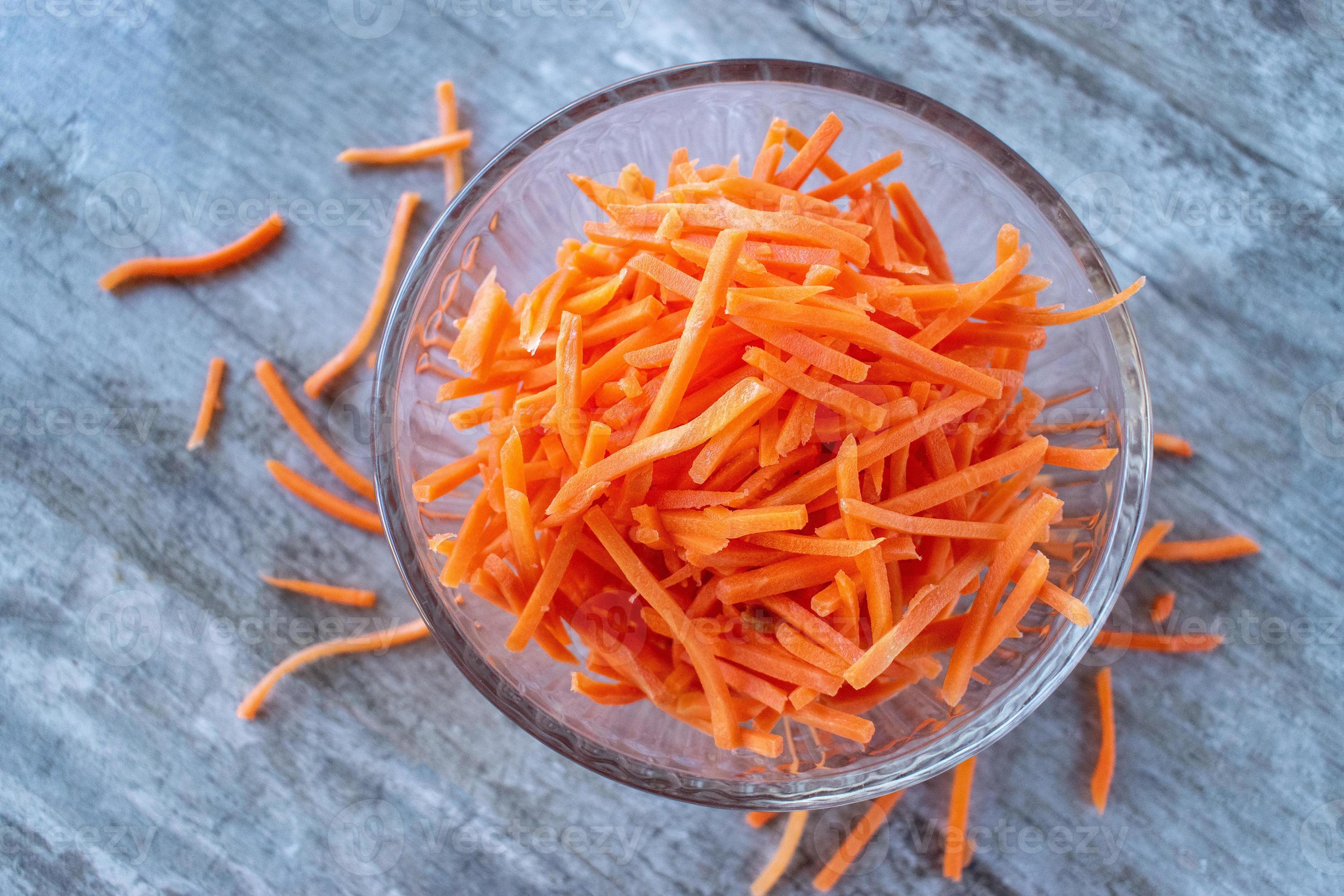 bowl full of orange julienne carrot sticks flat lay 8724894 Stock Photo
