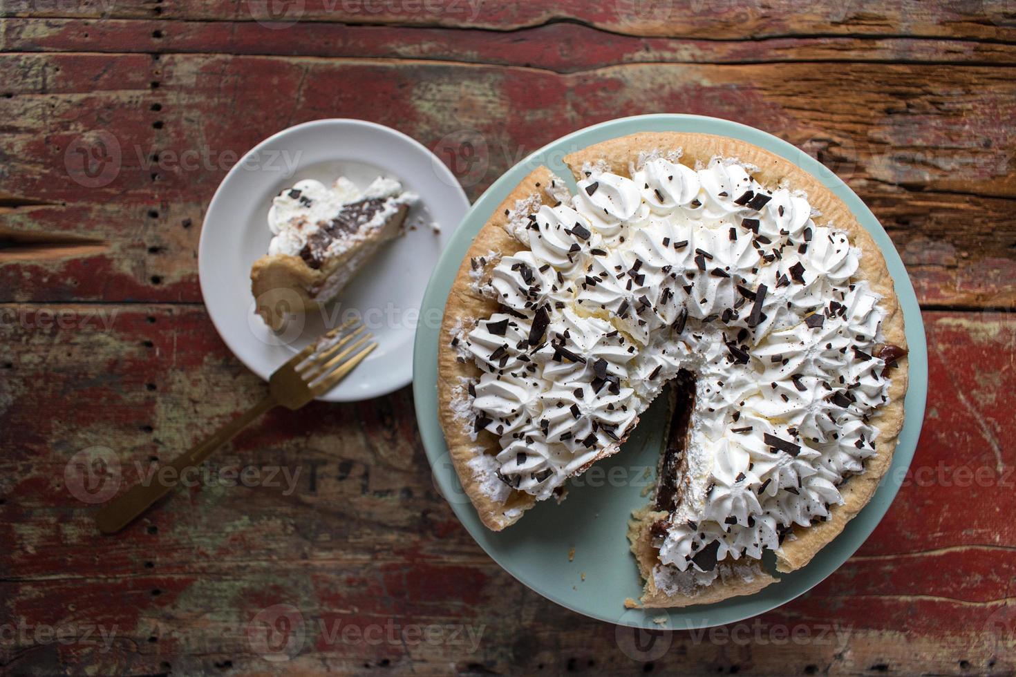chocolate pie with meringue and slice cut out photo