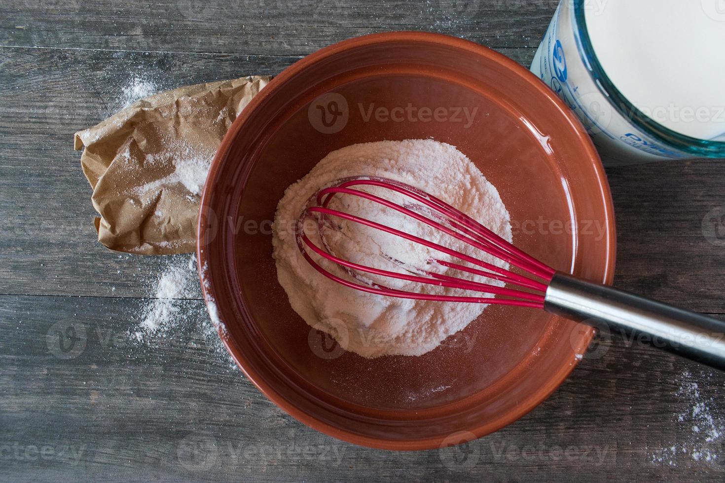 Mixing vanilla pudding with ingredients on rustic table Flat lay photo