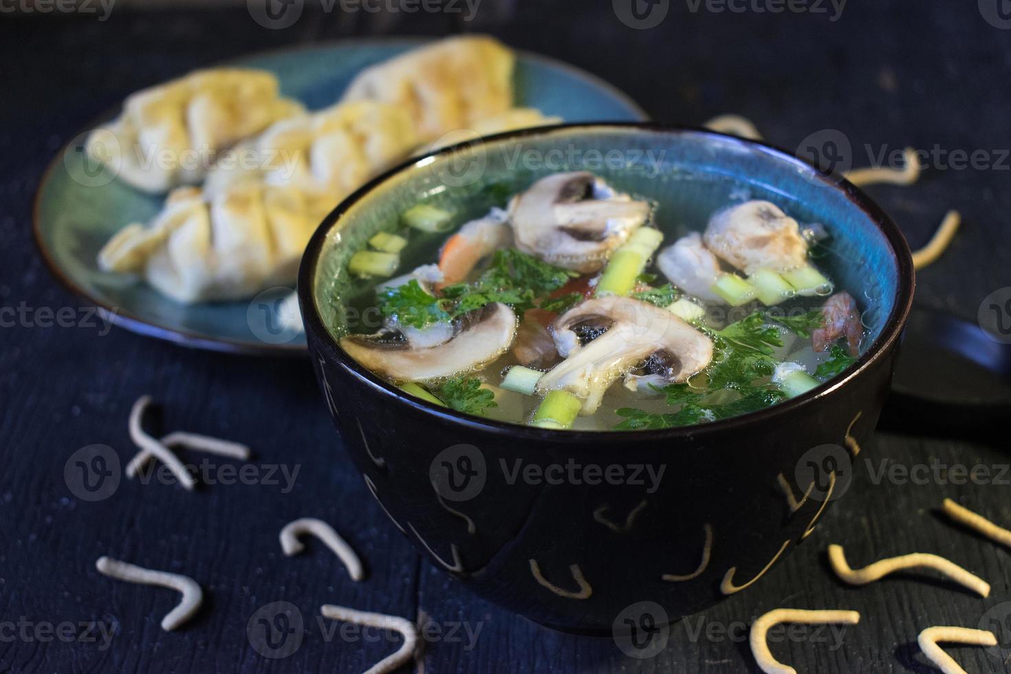 healthy clear broth soup with mushrooms and brocklie photo