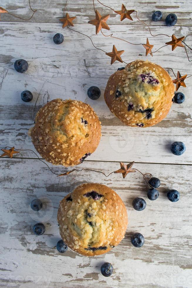 homemade blueberry muffins on rustic wood top view photo