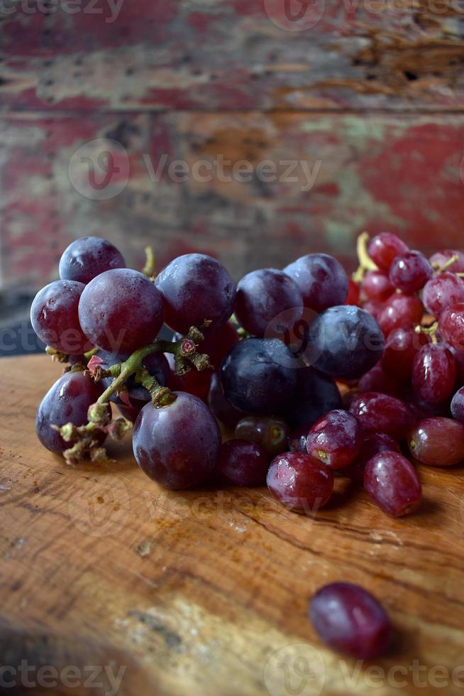 red and blue grapes on cutting board closeup photo