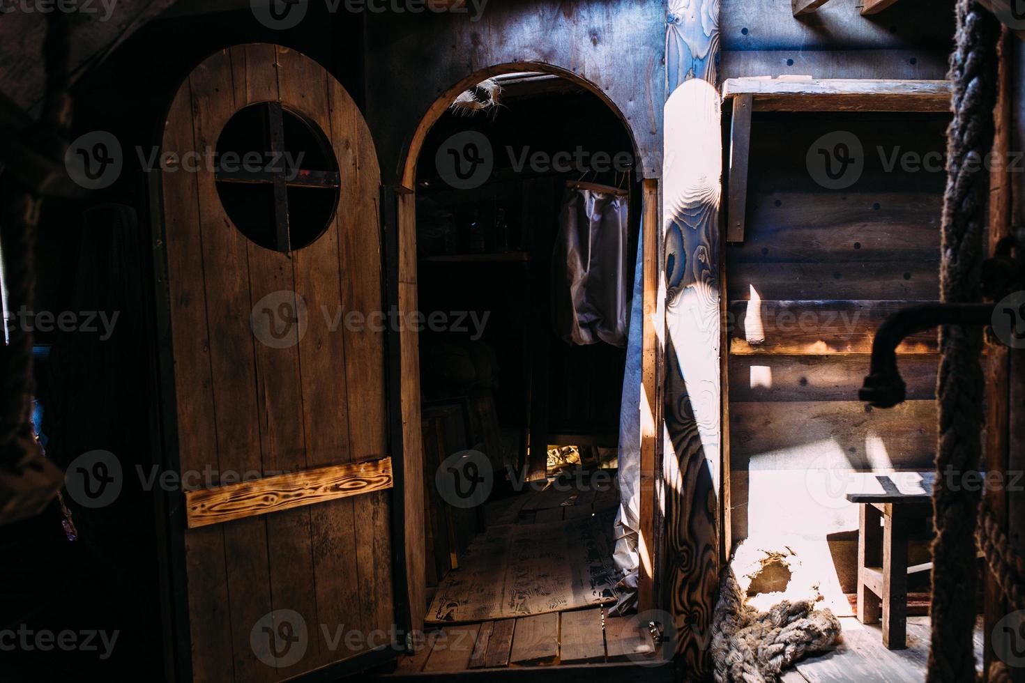 Wooden winch of a sailing ship and ropes on the deck of medieval pirate warship photo