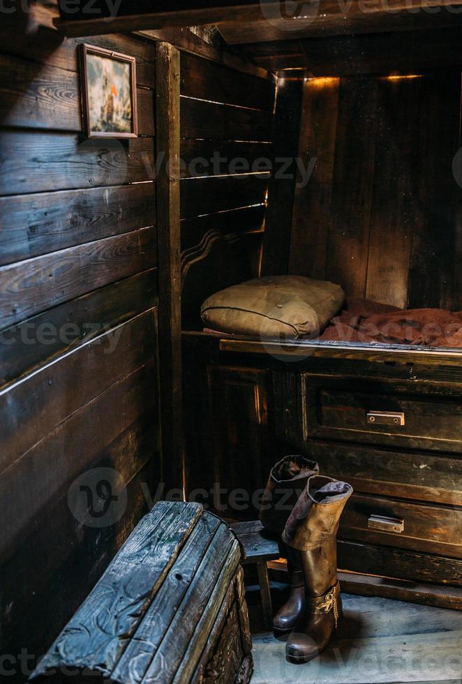 Wooden winch of a sailing ship and ropes on the deck of medieval pirate warship photo