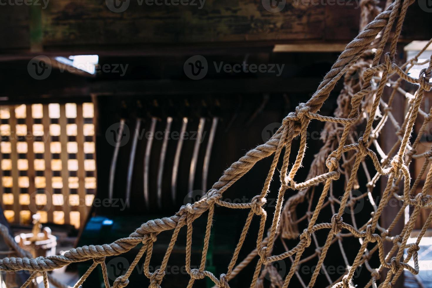 Wooden winch of a sailing ship and ropes on the deck of medieval pirate warship photo