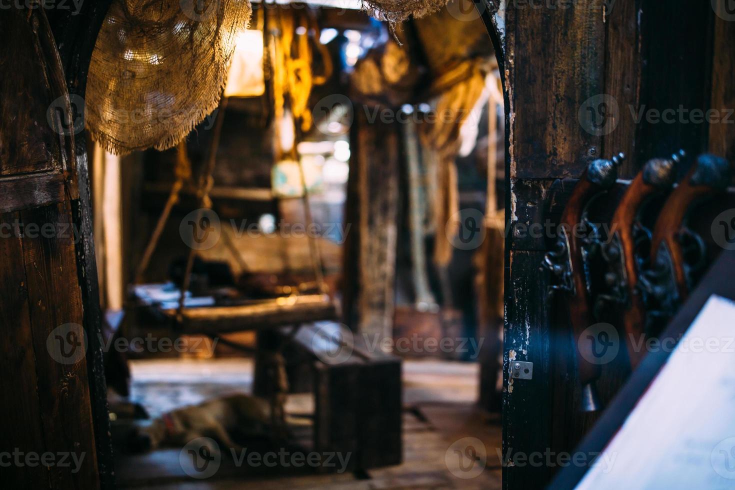 Wooden winch of a sailing ship and ropes on the deck of medieval pirate warship photo