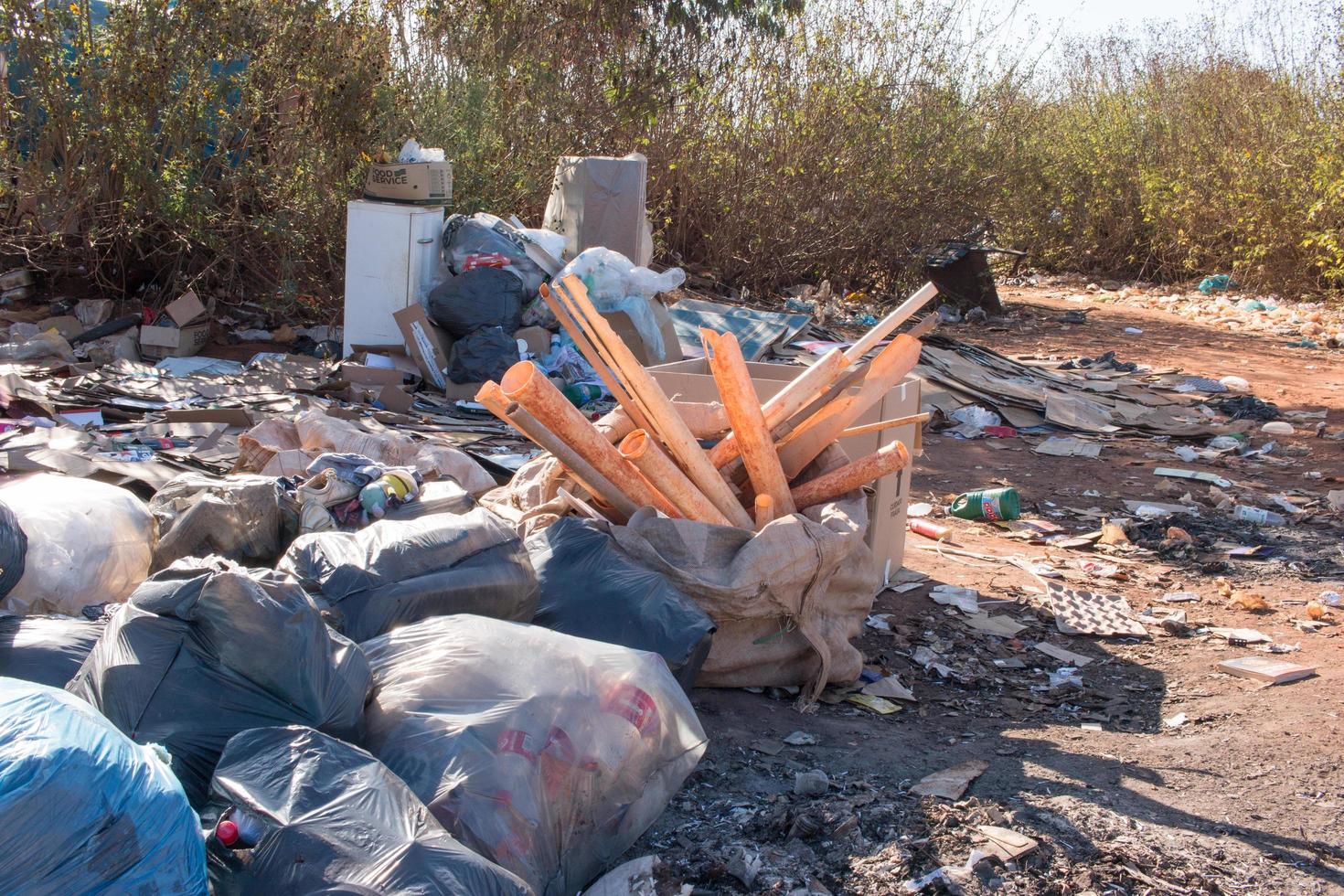 Brasilia, Brazil, June 20, 2022 Trash mostly cardboard and plastic bottles that homeless people pick up and dump out where the live in the Northwest sector of Brasilia photo