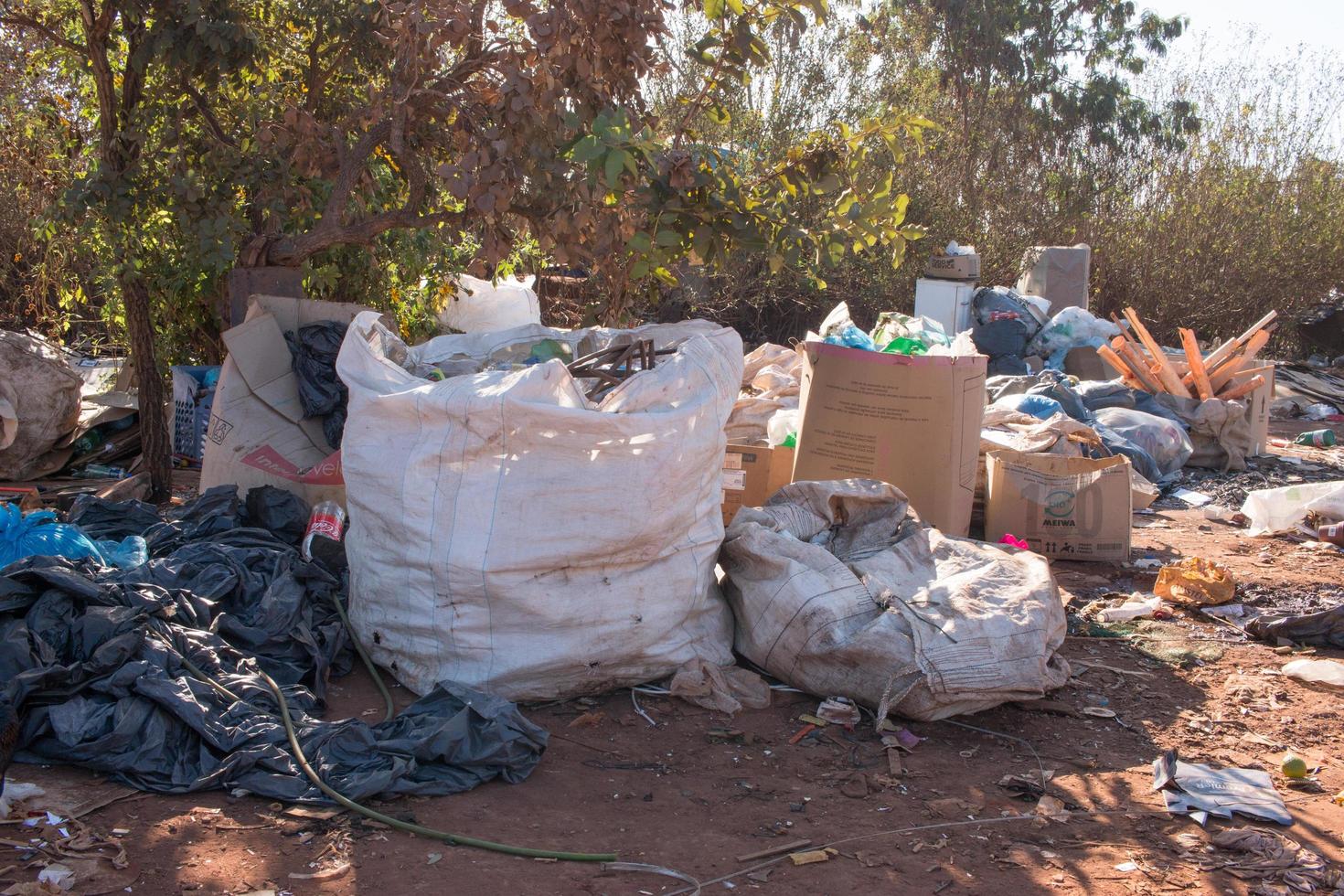 Brasilia, Brazil, June 20, 2022 Trash mostly cardboard and plastic bottles that homeless people pick up and dump out where the live in the Northwest sector of Brasilia photo