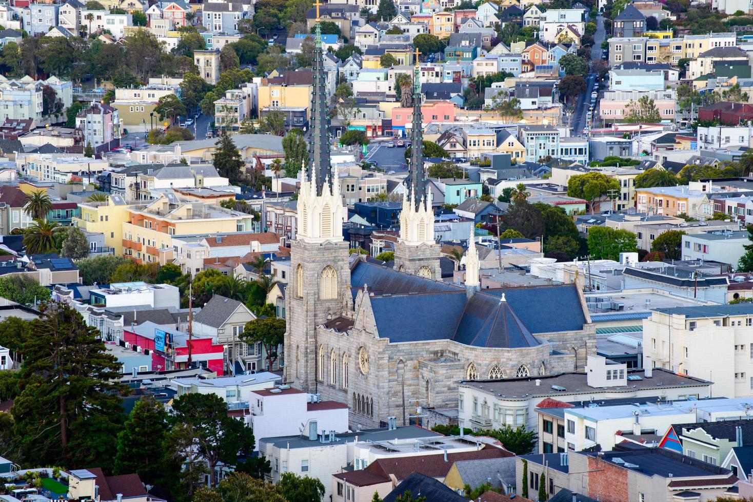 Golden hour neighborhood hill view of San Francisco homes, peaked roofs - colorful and scenic with some Victorian homes - a typical San Francisco view. photo