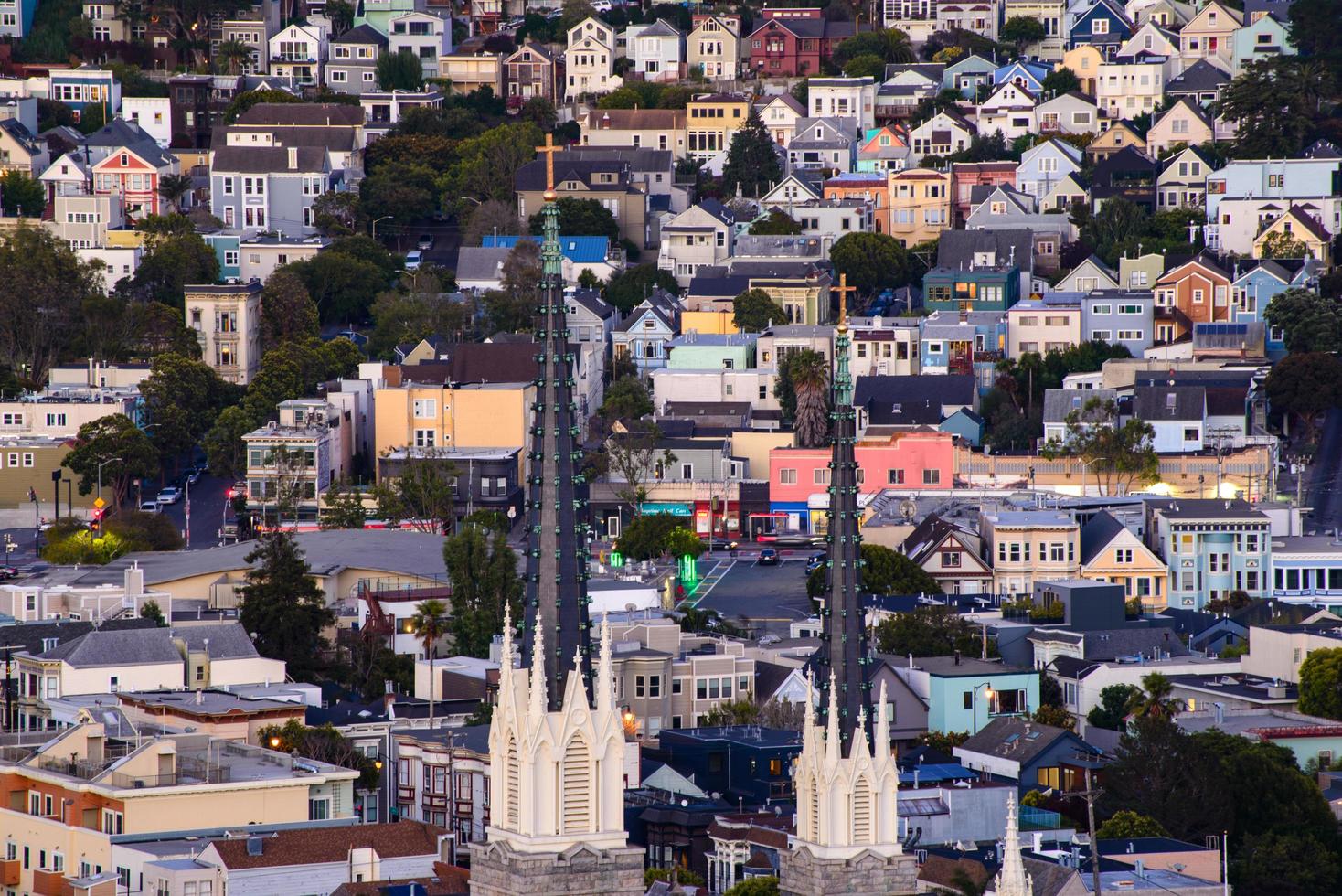 Golden hour neighborhood hill view of San Francisco homes, peaked roofs - colorful and scenic with some Victorian homes - a typical San Francisco view. photo