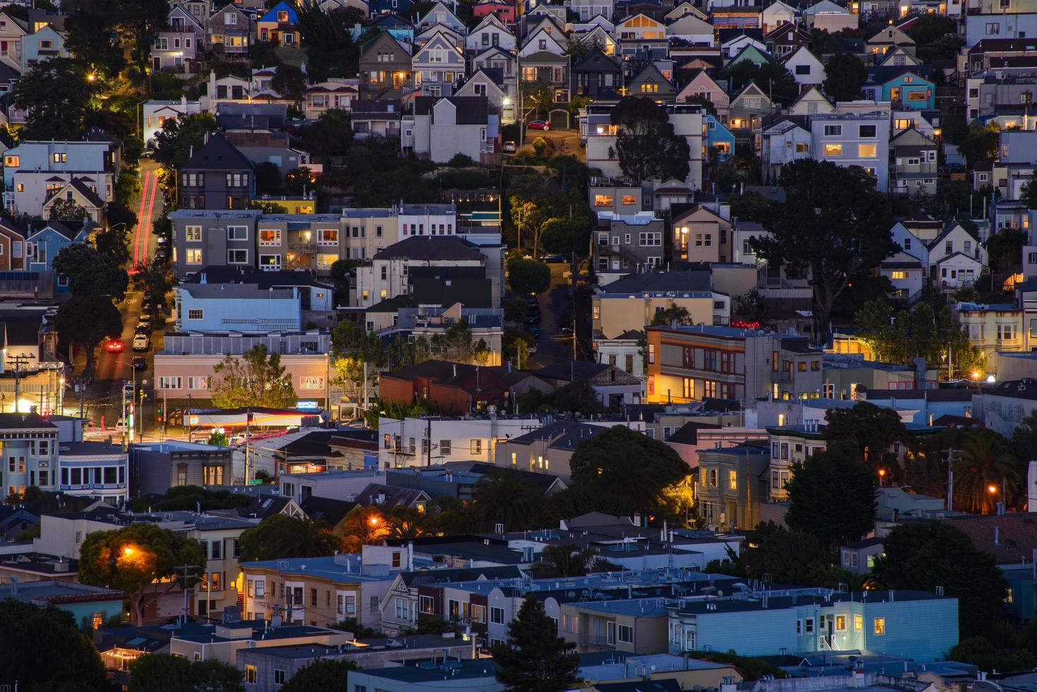 Golden hour neighborhood hill view of San Francisco homes, peaked roofs - colorful and scenic with some Victorian homes - a typical San Francisco view. photo