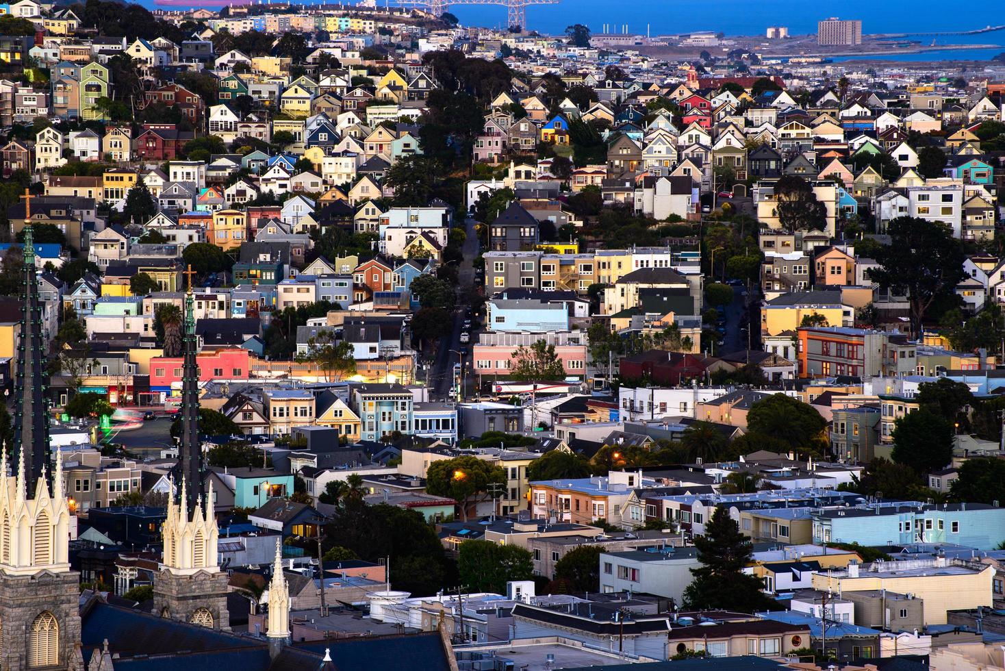 Golden hour neighborhood hill view of San Francisco homes, peaked roofs - colorful and scenic with some Victorian homes - a typical San Francisco view. photo