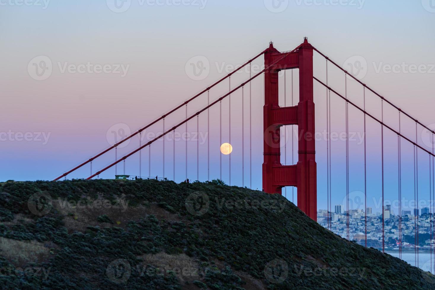 Majestic San Francisco Golden Gate Bridge with June 2022 full moon rising and the north tower as seen from Marin Headlands in California photo