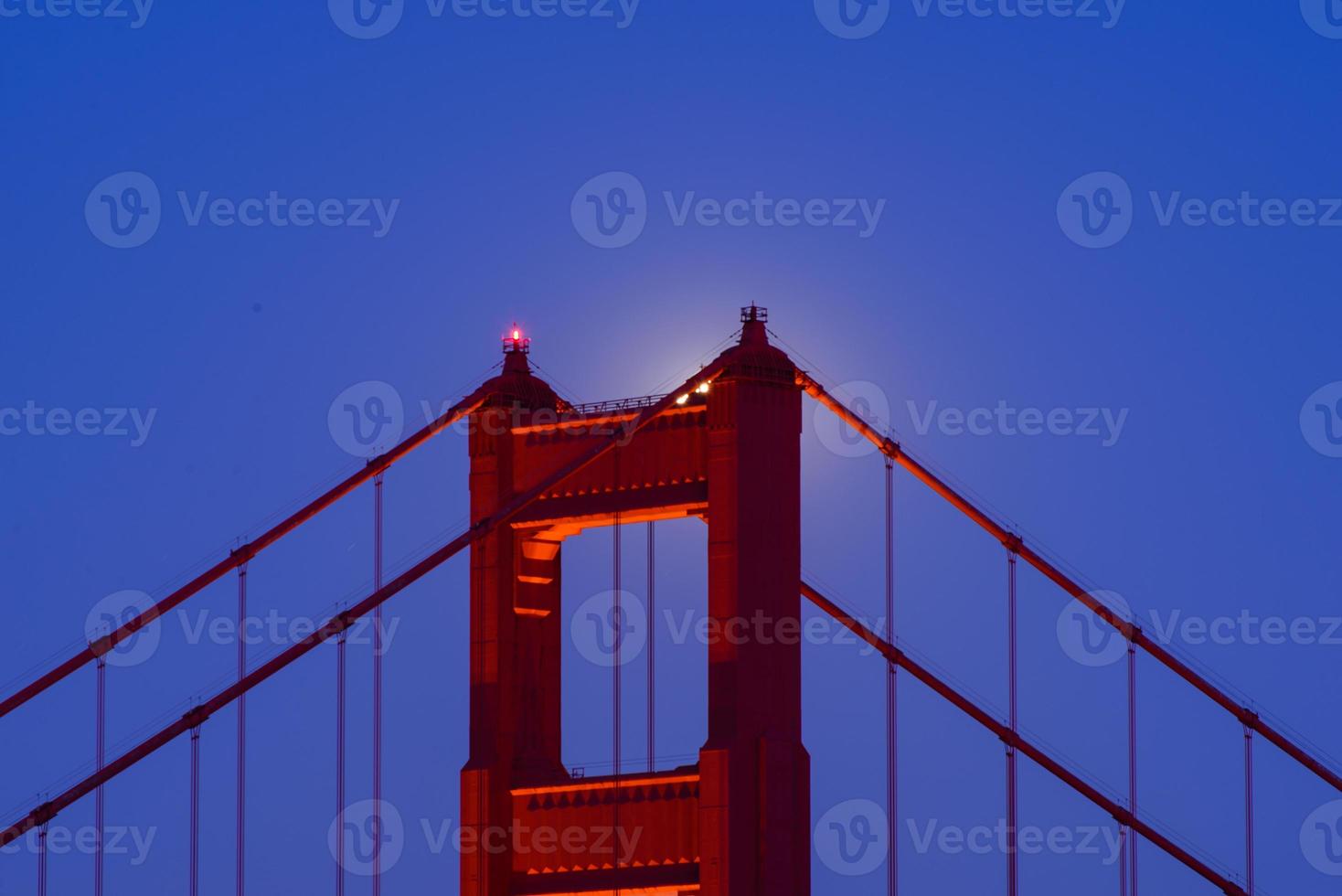 Majestic San Francisco Golden Gate Bridge with June 2022 full moon rising and the north tower as seen from Marin Headlands in California photo