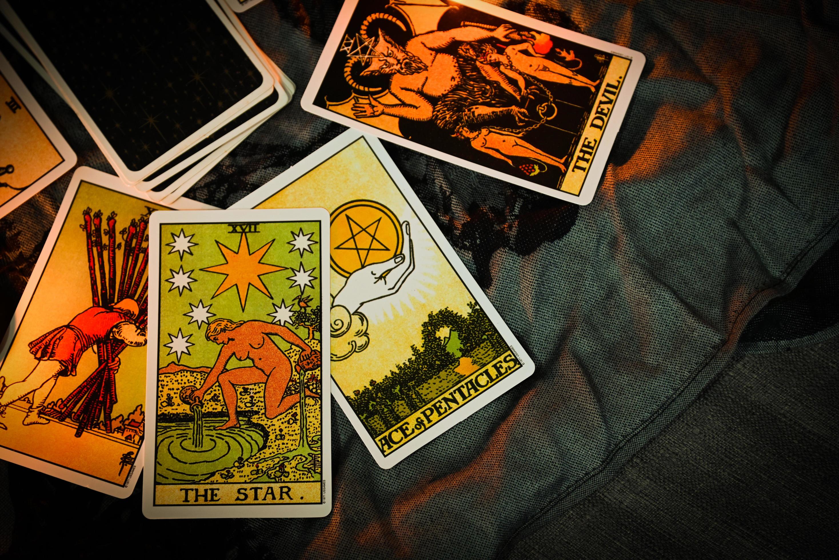 Tarot reading with tarot card background and candlelight on the table for  Astrology Occult Magic Spiritual Horoscopes and Palm reading fortune teller  tarot reader 8726310 Stock Photo at Vecteezy