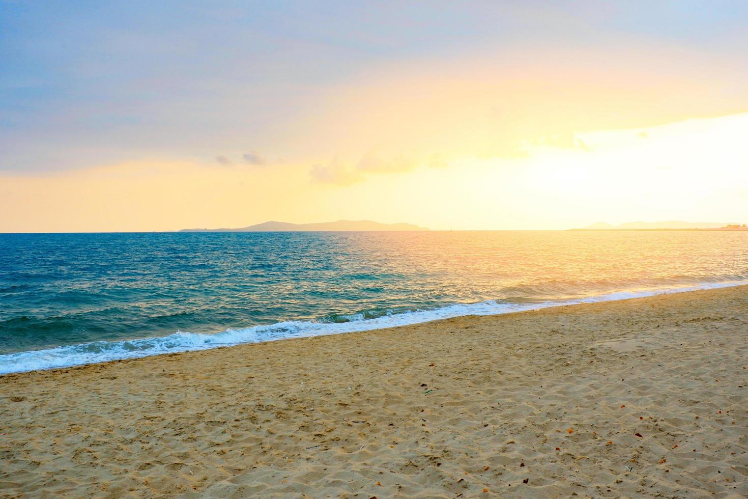 Sunset on the beach sea with cloud yellow sky background in the summer photo