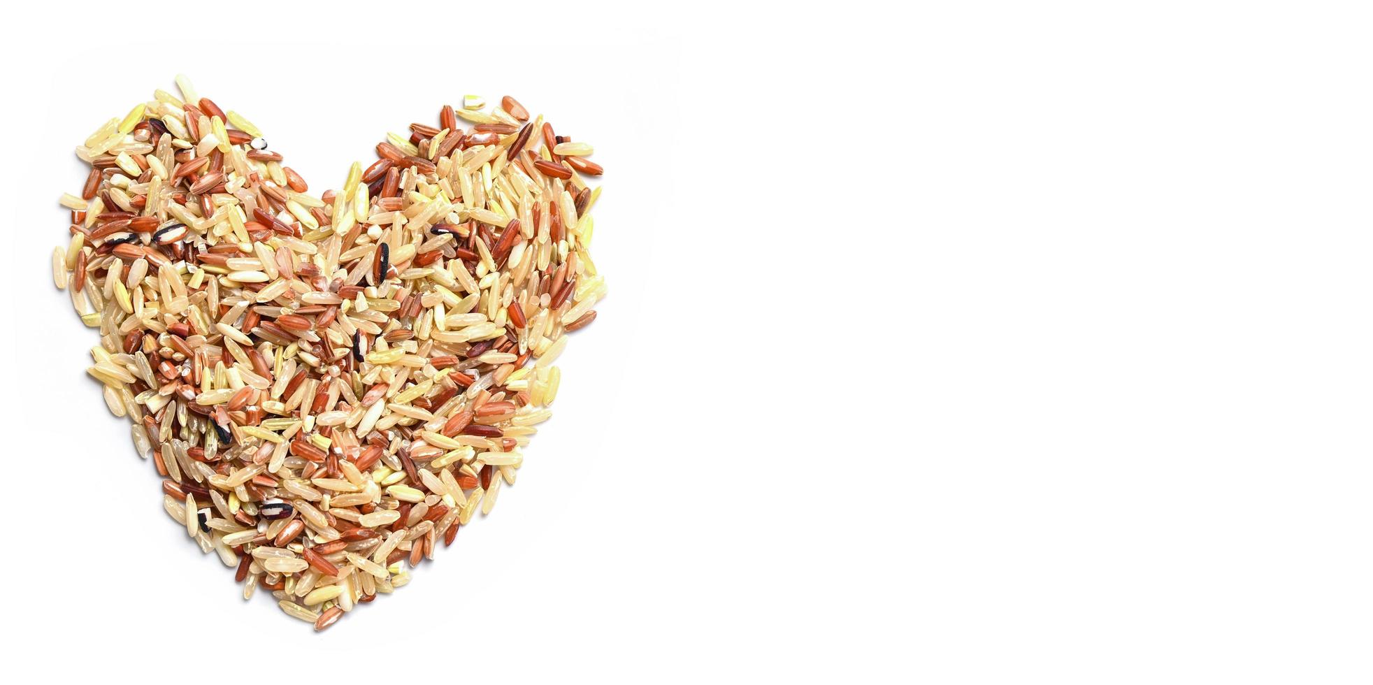 heart rice , brown rice on white background , various color mixed thai rice for cooking food , Loonzain rice brown black red white purple health food background. photo