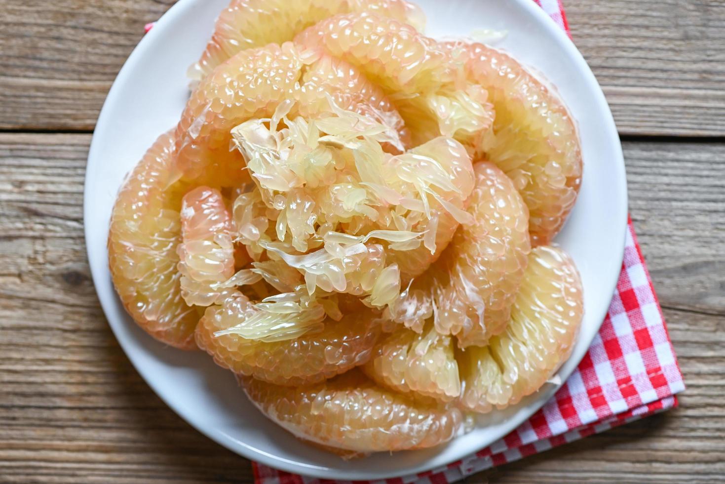 Pomelo fruit on wooden plate, fresh pomelo peeled frome pomelo tree , pummelo , grapefruit in summer tropical fruit in thailand photo