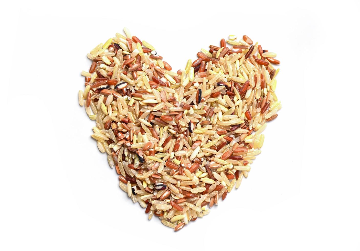 heart rice , brown rice on white background , various color mixed thai rice for cooking food , Loonzain rice brown black red white purple health food background. photo