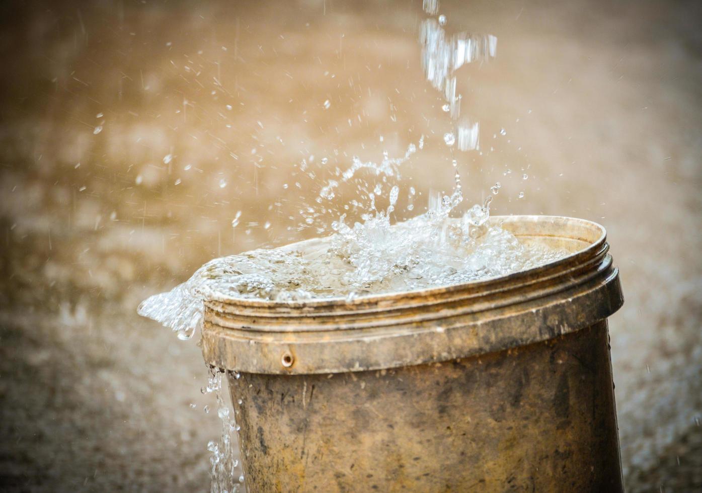 recolección de agua de lluvia en el balde después de fuertes lluvias foto