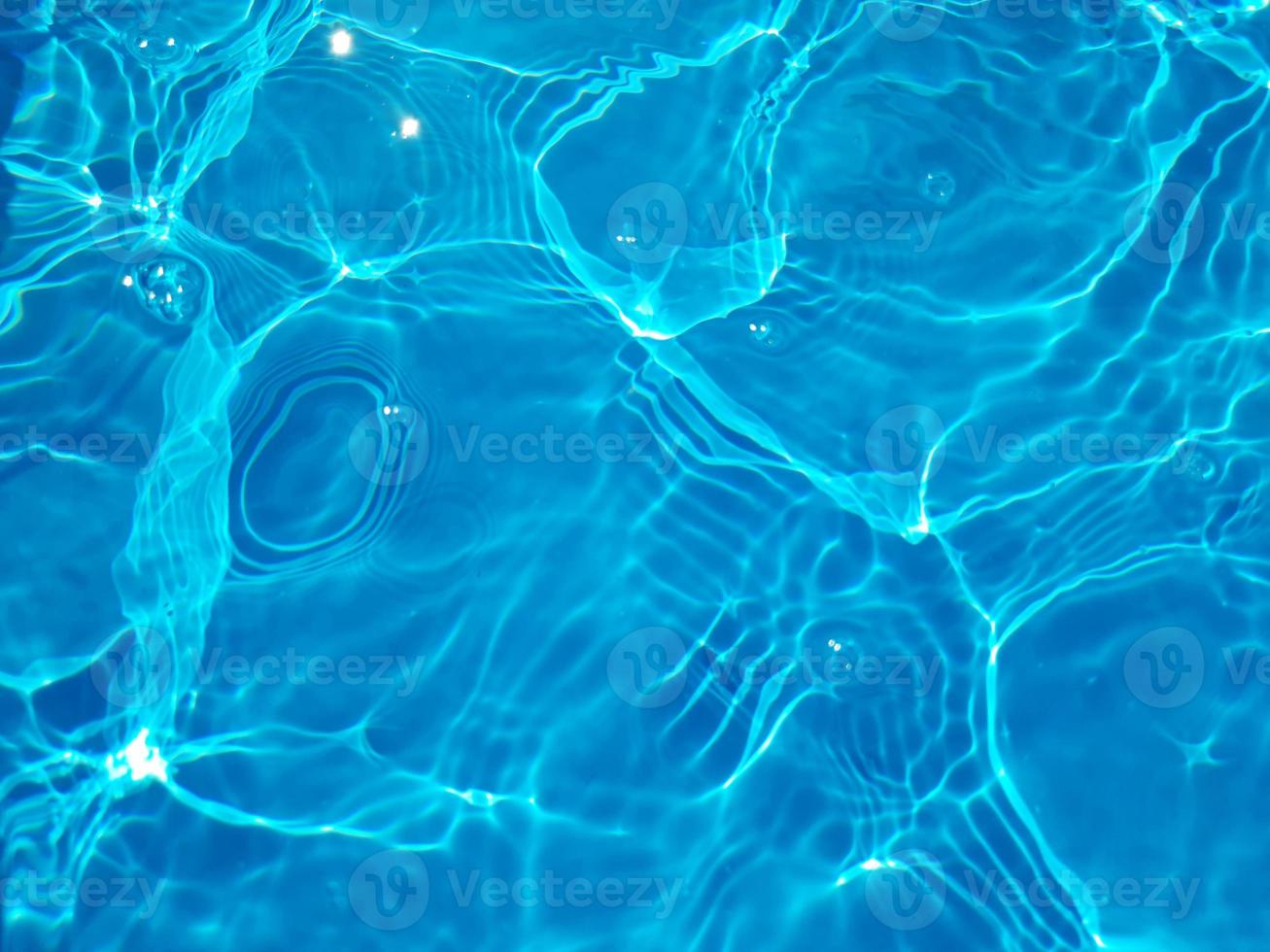 Defocus blurred blue watercolor in swimming pool rippled water detail background. Water splash, water spray background. photo