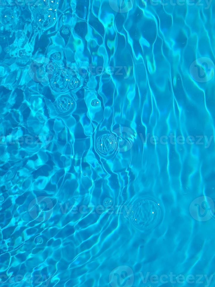 Defocus blurred blue watercolor in swimming pool rippled water detail background. Water splash, water spray background. photo