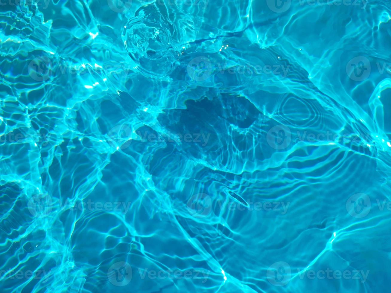 Defocus blurred blue watercolor in swimming pool rippled water detail background. Water splash, water spray background. photo