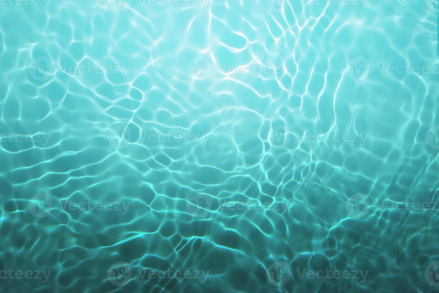 Defocus blurred blue watercolor in swimming pool rippled water detail background. Water splash, water spray background. photo