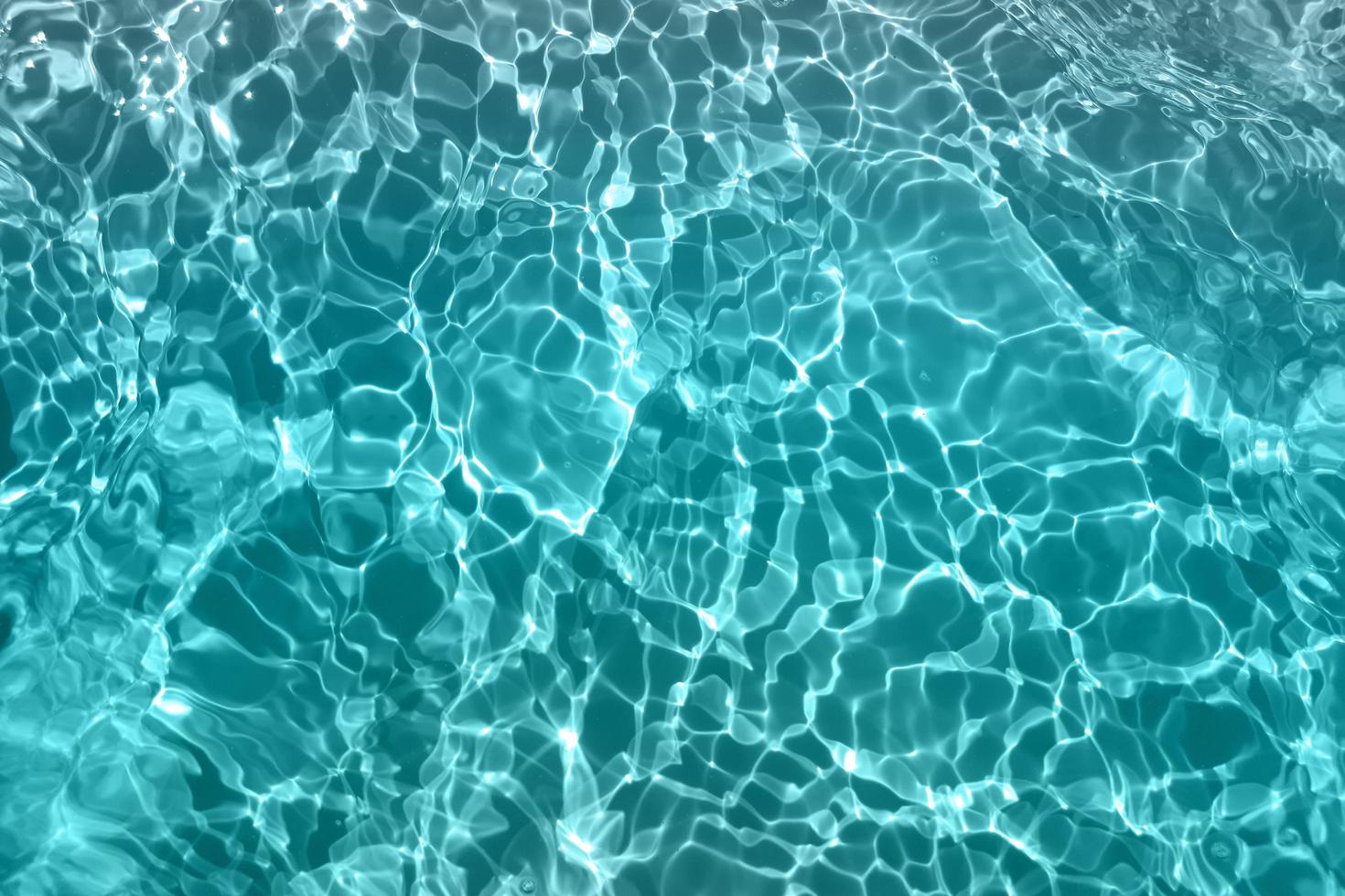 Defocus blurred blue watercolor in swimming pool rippled water detail background. Water splash, water spray background. photo