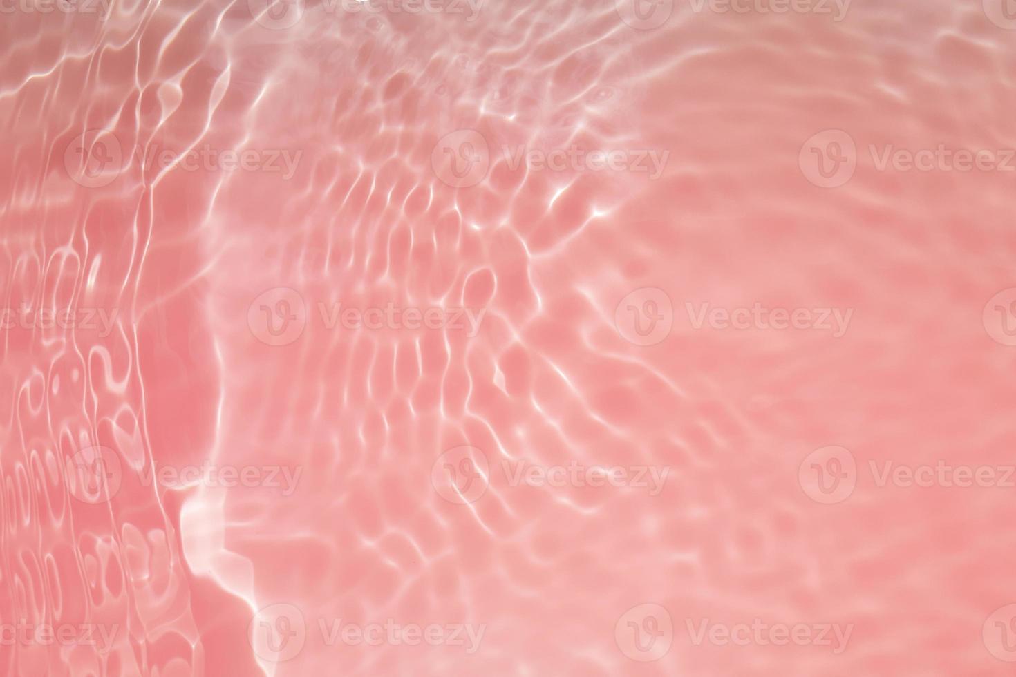 Defocus blurred red watercolor in swimming pool rippled water detail background. Water splash, water spray background. photo