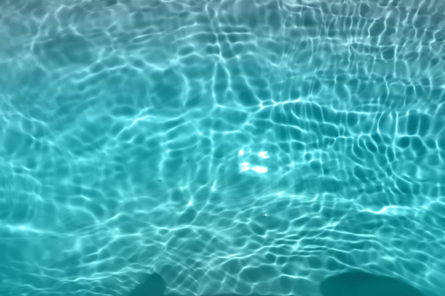 Defocus blurred blue watercolor in swimming pool rippled water detail background. Water splash, water spray background. photo