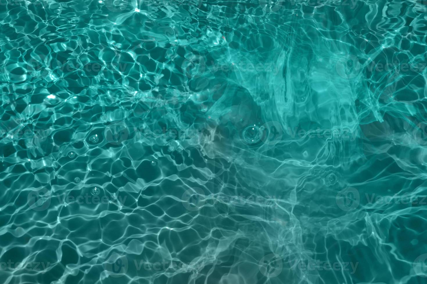 Defocus blurred blue water splash in the sea rippled water detail background. Water splash, water spray background. photo