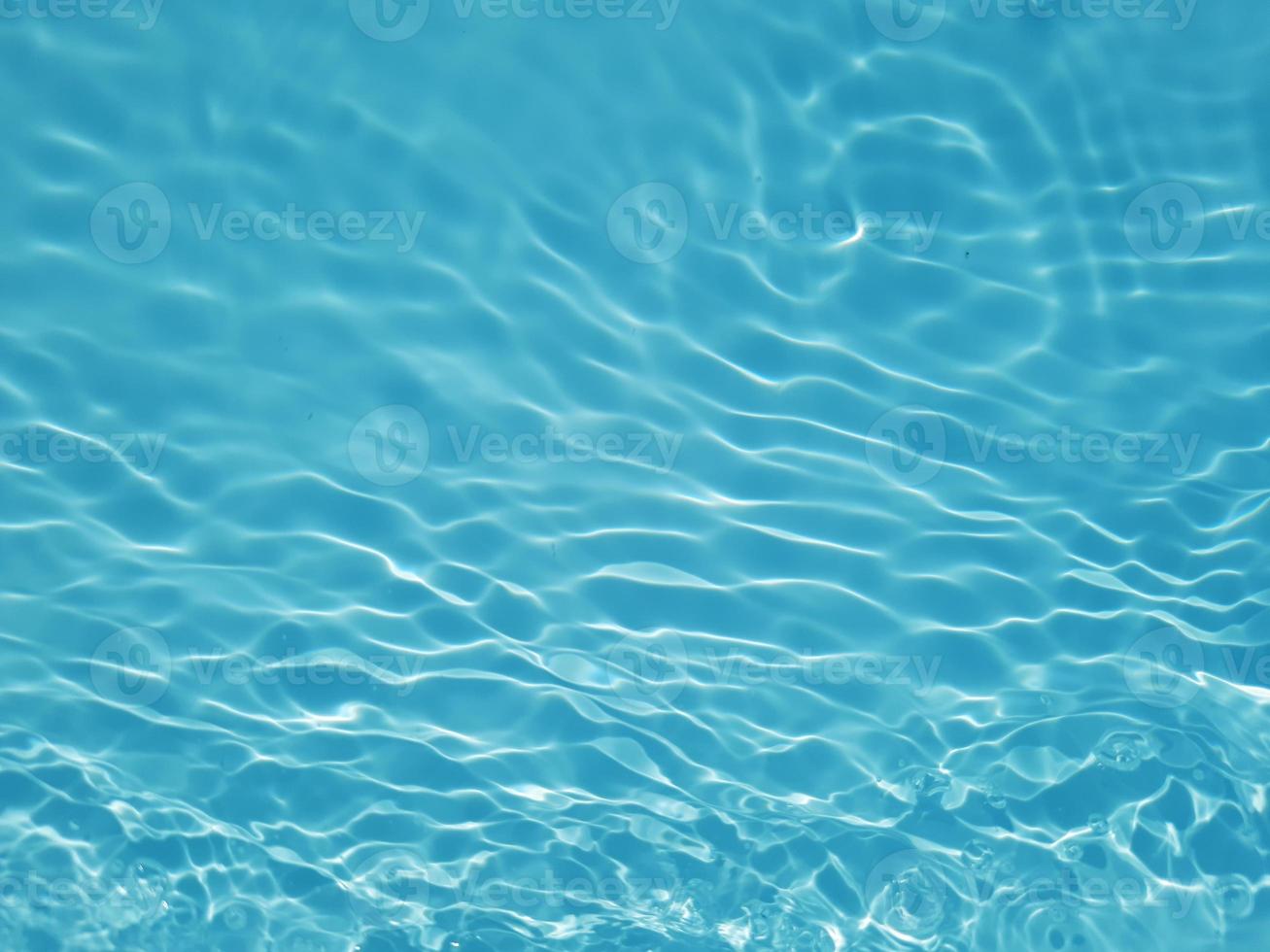 Defocus blurred blue watercolor in swimming pool rippled water detail background. Water splash, water spray background. photo