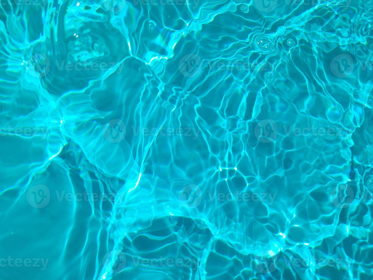 Defocus blurred blue watercolor in swimming pool rippled water detail background. Water splash, water spray background. photo