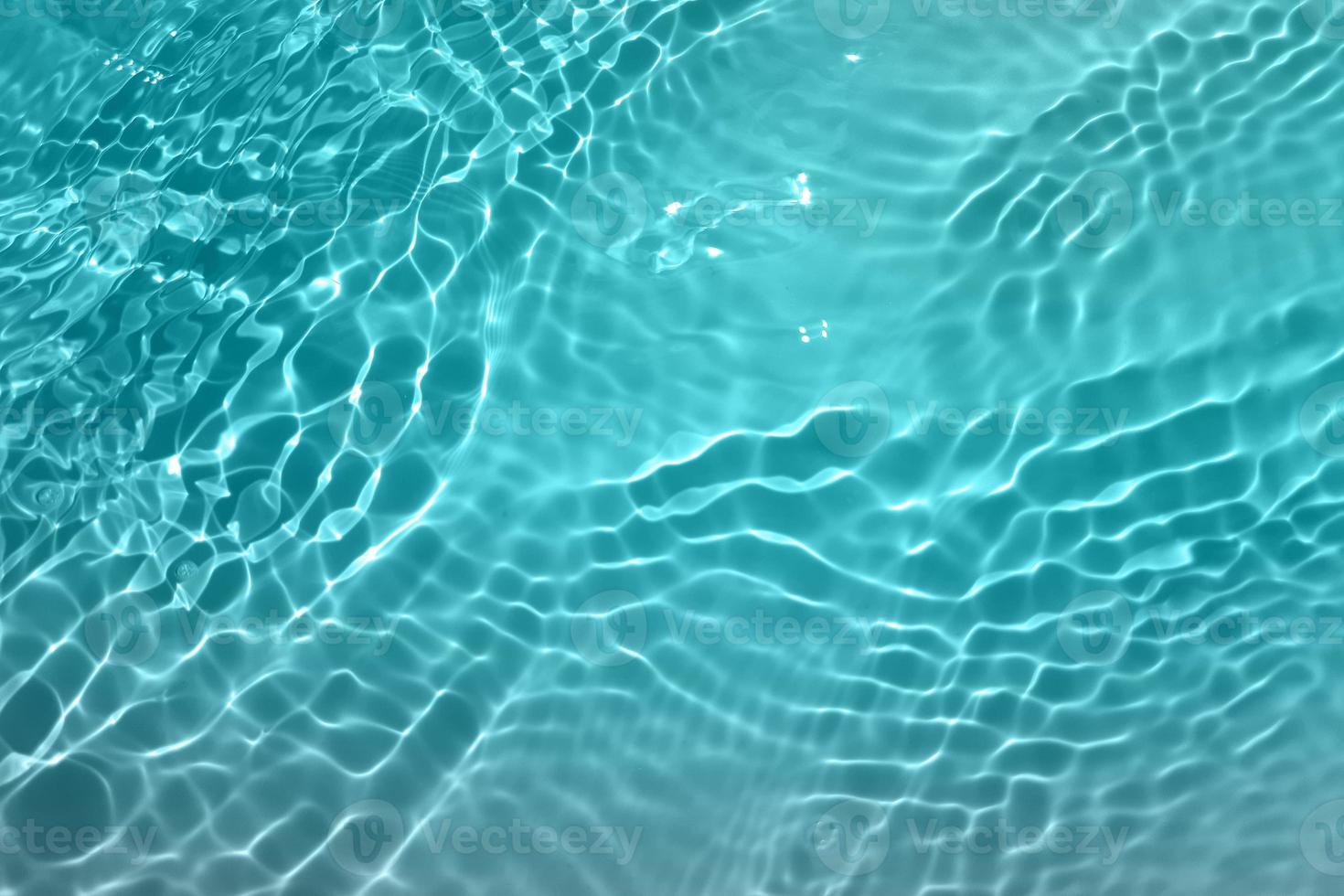 Defocus blurred blue watercolor in swimming pool rippled water detail background. Water splash, water spray background. photo