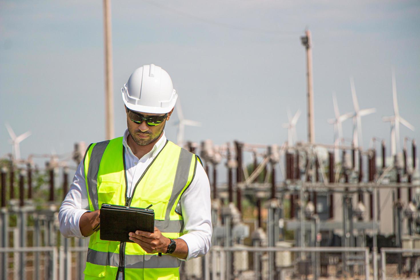 engineer team working in wind turbine farm. Renewable energy with wind generator by alternative energy concept. photo