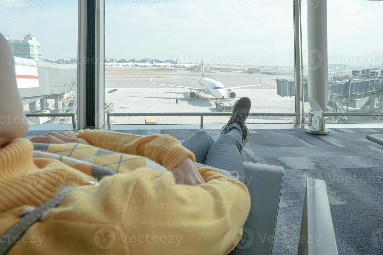 Young female passenger waiting for flight. photo