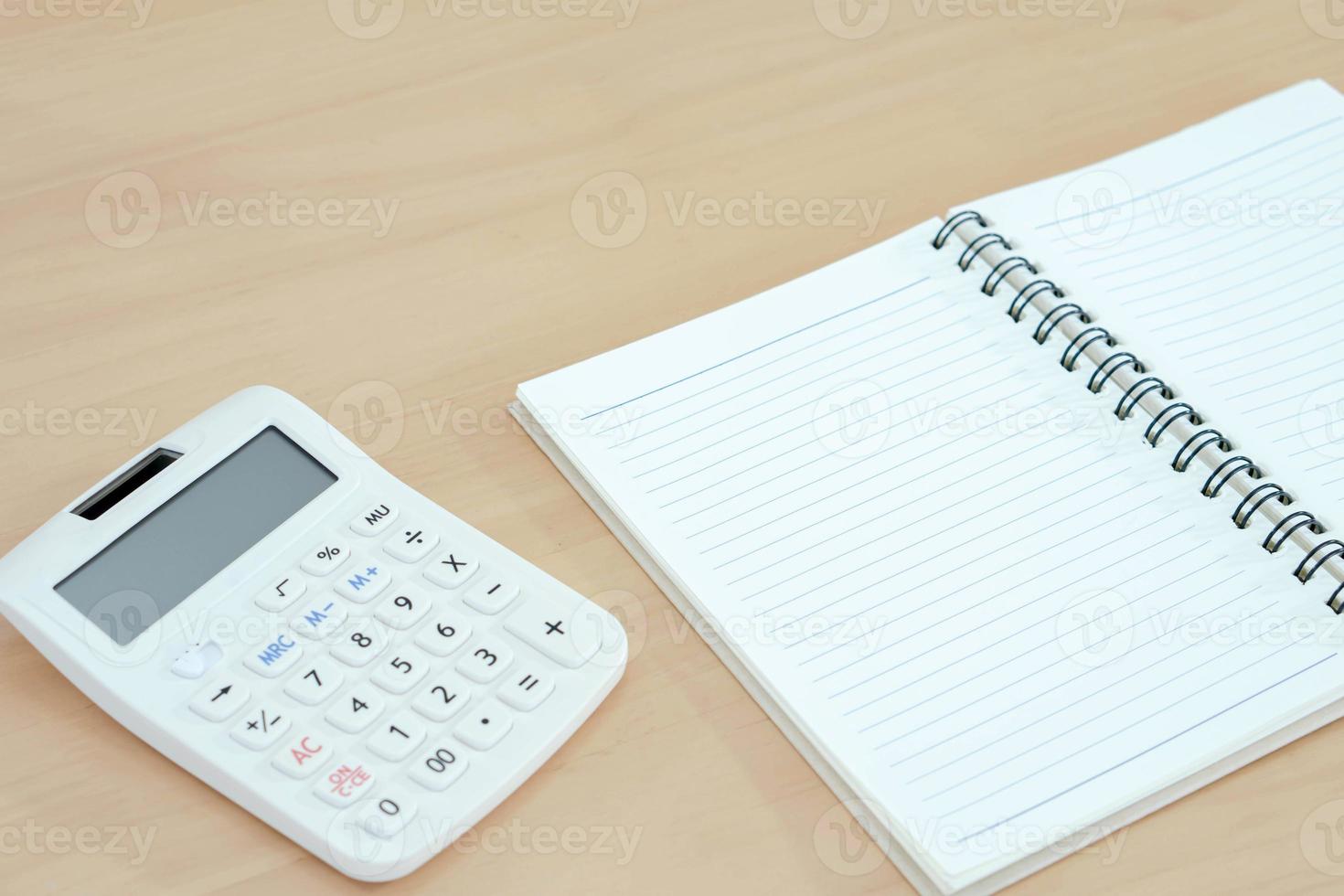 Notebook, calculator on wood photo