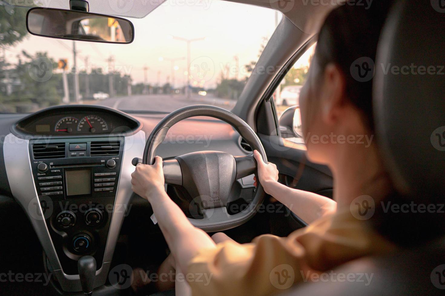 Rear view of cool woman in driving car photo