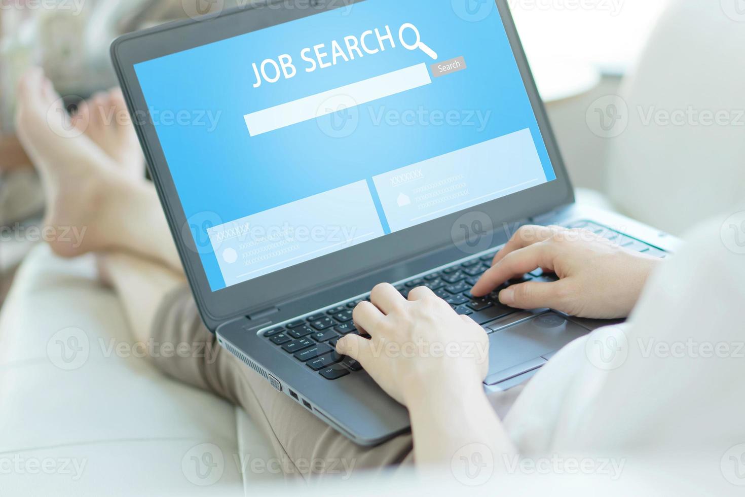 Woman trying to find work with online job search engine on laptop photo