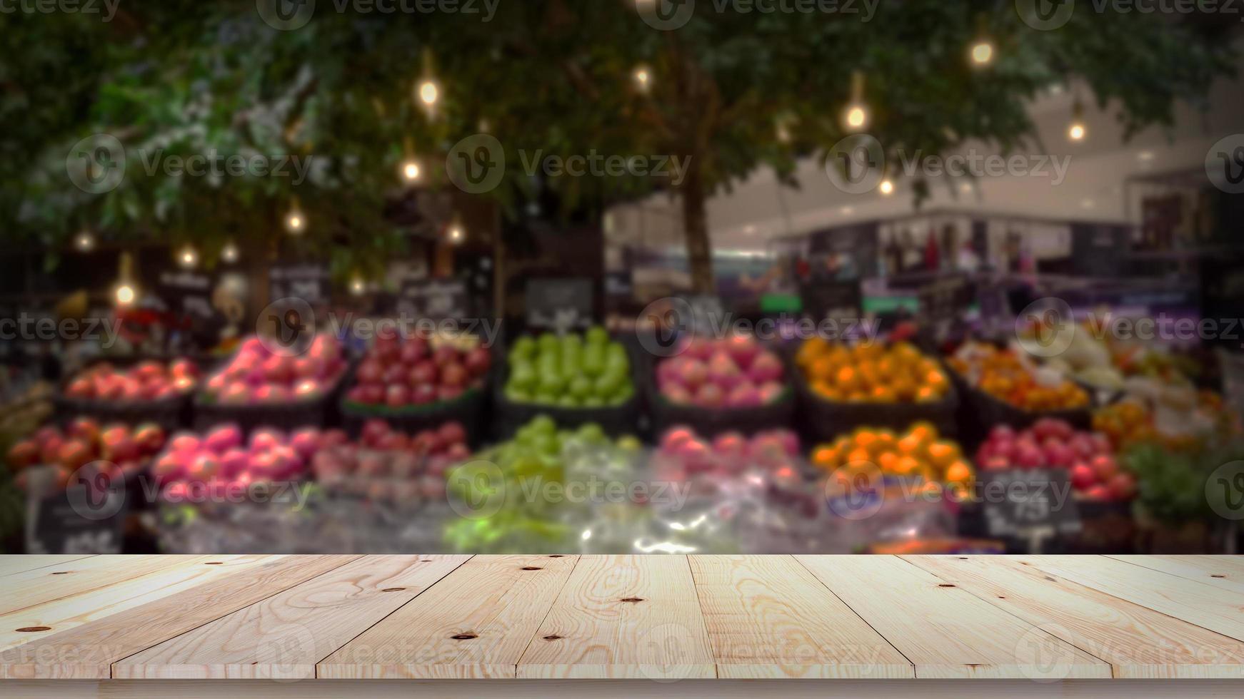 Empty wood table top with fruit market blurred background photo