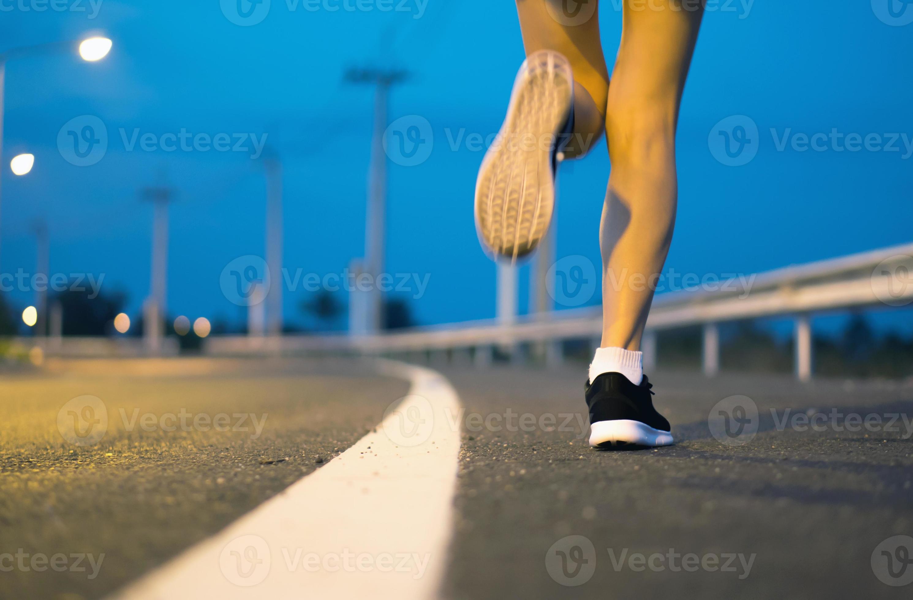 Movement. Woman legs running on asphalt road. 8727959 Stock Photo at